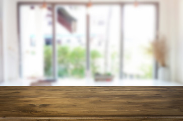 Selected focus empty brown wooden table and Coffee shop blur background with bokeh image. for your photomontage or product display