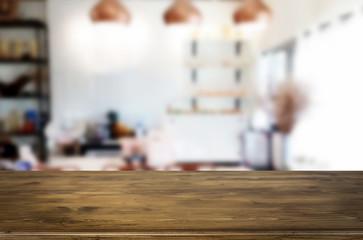 Obraz premium Selected focus empty brown wooden table and Coffee shop blur background with bokeh image. for your photomontage or product display