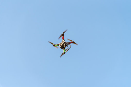 Drone with camera on blue sky. New technology for bird eye view photography.