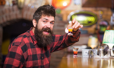 Hipster holds glass with alcoholic drink, short cocktail.