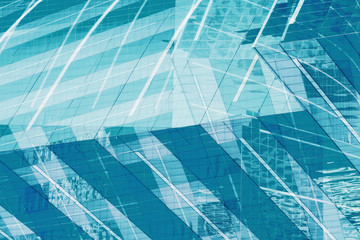 Angle view of texture background of contemporary glass facade of architecture building skyscrapers with the light reflect of sky and cloud.