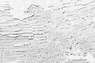 Old white concrete wall with plaster seamless background photo texture