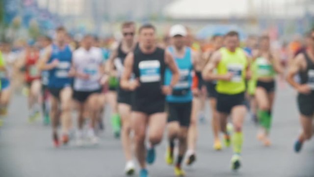 Sportsmen runners at the marathon in the city, blurred, slow-motion