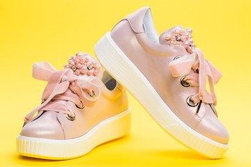 Comfortable footwear concept. Footwear for girls or women decorated with pearl beads. Cute shoes on...