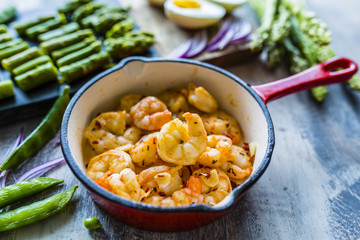 Fried shrimps and green asparagus with peas salad ingredients. 