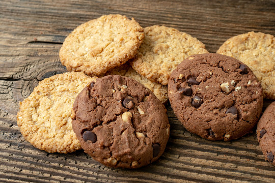 Various tasty cookies biscuits on wooden background
