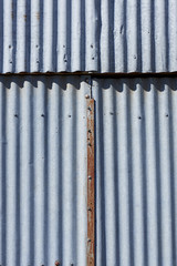 Obraz premium Corrugated iron with a rusted metal strip in the middle 