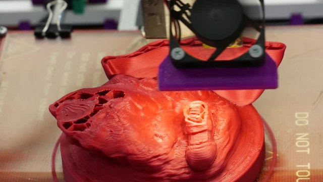 Modern 3D printer printing figure close-up macro