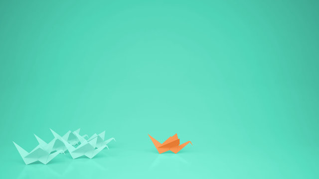 Origami orange paper crane leading group of cranes, leadership motivation concept idea with copy space, turquoise background