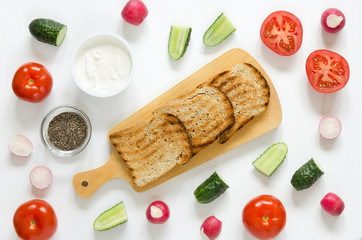 Ingredients for sandwiches: cream cheese, fresh cucumber, radish, tomato, chia seeds on white background