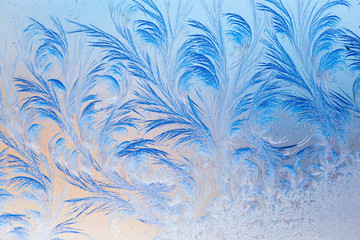 Blue drawings on the glass in the frost