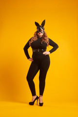 Seductive curvy girl wearing leather bunny mask