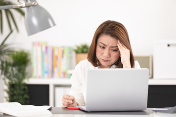 Fototapeta premium Asian woman using laptop at home office,