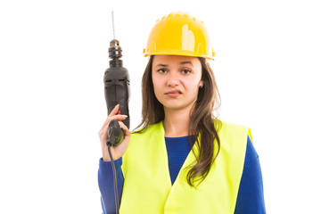 Young female architect holding drilling machine.