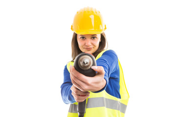 Young woman engineer using drilling machine.