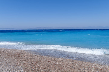 Fototapeta na wymiar Blue turquoise natural sea gentle waves at the coast