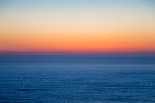 Fototapeta Seascape with colorful evening sky. Natural background. Beautiful sunset over the sea in the Atlantic ocean.
