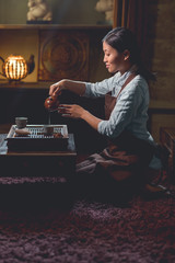 Young tea master pouring tea indoors