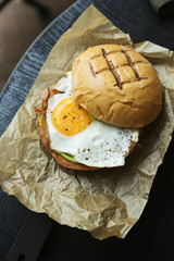 Freshly made burger with fried egg and bacon