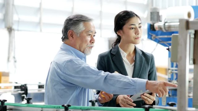 Business people talking for project on the factory floor. People working at industry concept. 