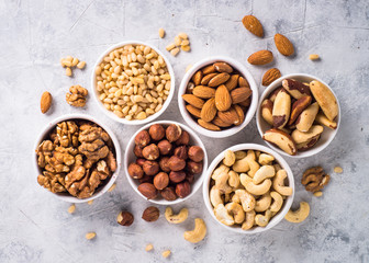 Nuts assortments on stone table top view.