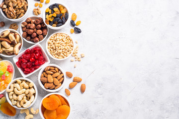 Nuts and dried fruits assortment on stone table top view.