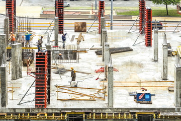 Construction workers are working on a construction site in Kiev, Ukraine. Concrete construction works and assembly of metal structures are carried out.