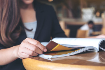 Closeup image of a business woman reading a book in modern cafe