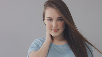 young caucasian woman with long hair moved by wind slowly blye eyed model portrait, ideal young skin