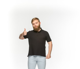 Closeup of young man's body in empty black t-shirt isolated on white background. Mock up for disign concept
