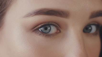 closeup of blue eyes of young woman looking at camera, Studio light ideal strobbing skin highlight