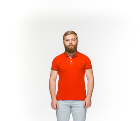 Closeup of young man's body in empty red t-shirt isolated on white background. Mock up for disign concept