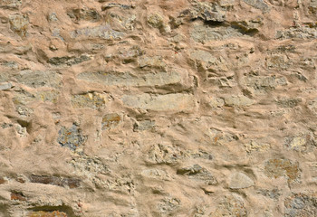 Stone block wall with mortar and plaster as background