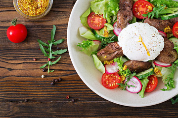Warm salad from chicken liver, radish, cucumber, tomato and egg poached. Healthy food. Dietary menu. Top view. Flat lay.