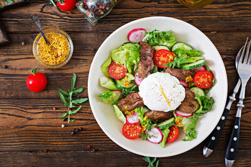 Warm salad from chicken liver, radish, cucumber, tomato and egg poached. Healthy food. Dietary menu. Top view. Flat lay.