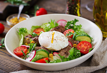 Warm salad from chicken liver, radish, cucumber, tomato and egg poached. Healthy food. Dietary menu
