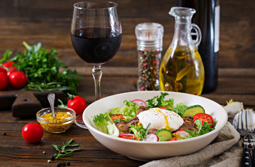 Warm salad from chicken liver, radish, cucumber, tomato and egg poached. Healthy food. Dietary menu
