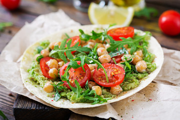 Vegan tacos with guacamole, chickpeas, tomatoes and arugula. Healthy food. Useful breakfast