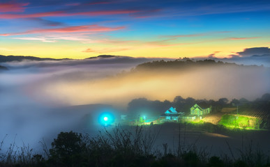 Sunrise over hillside as the sun rising from horizon reflect light bright yellow sky. Below cloudy mist covered valleys flooded pine forests create impressive beauty highlands in morning.