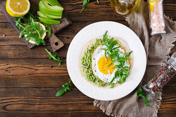 Tacos with guacamole, fried egg and arugula. Healthy food. Useful breakfast. Flat lay. Top view