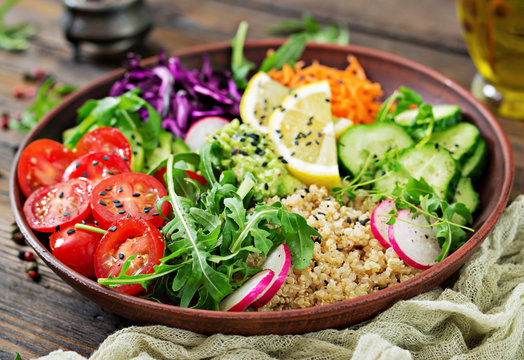 Vegetarian Buddha bowl with quinoa and fresh vegetables. Healthy food concept. Vegan salad.