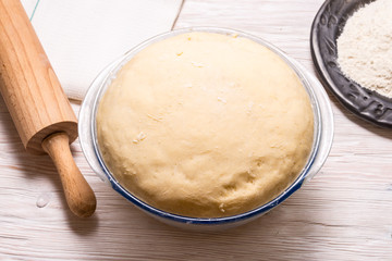 Yeast dough on wooden table.