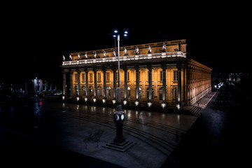 Fototapeta premium Bordeaux, France, 10 may 2018 -The grand Opera House 'Grand Théâtre de Bordeaux' at night on the Main square 'Place de La Comedie' in the center of town