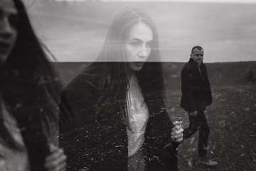 Dramatic double exposure effects on men's hand combined with portrait of beautiful girl. Vintage sepia style. Conceptual, abstract. Loneliness, freedom, dreaming. Relaxing in the wavy world of dreams.