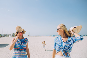 Beautiful young women having fun at beach on a sunny day