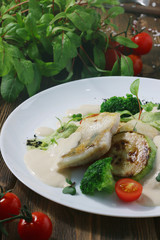 white fish with broccoli close up on greeny background