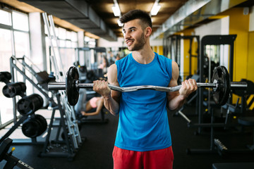 Fototapeta na wymiar Determined male exercising in gym