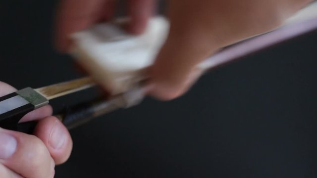 Applying Rosin to a Violin Bow