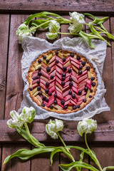 Rhubarb and blueberry pie, cake, tart. Isolated. Dark wooden table.