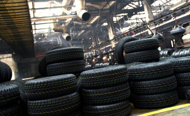 Tires production plant site. New cars tires stacking up on the workshop floor 